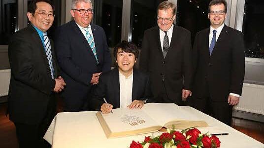 Lang Lang beim Eintrag ins Goldene Buch Bambergs. Hinter ihm (v. l.) Stadtrat You Xie, Dritter Bürgermeister Wolfgang Metzner, OB Andreas Starke, Zweiter Bürgermeister Christian Lange