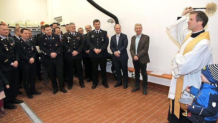 Pfarrer Matthias Steffel weihte die neue Fahrzeughalle im Anbau des Feuerwehrhauses Schlammersdorf ein.  Foto: Mathias Erlwein