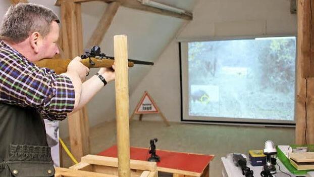 Wolfgang Lappe beim Schießen auf einen Keiler auf der Leinwand im Fierster Feuerwehrhaus.