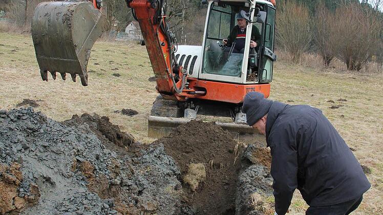 Baggerfahrer Manfred Fischer hob auf seiner Wiese eine vier Meter tiefe Grube für die Baugrunduntersuchung aus. Thomas Röckel begutachtete die unterschiedlichen Schichten: Humus (braun), wasserundurchlässige Tonschicht (graublau) und Kies (die Steine links neben der Schürfstelle.