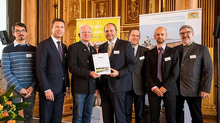 So sehen Sieger aus: Auch Michael Busch (rechts) als stellvertretender Vorsitzender der AGFK Bayern freute sich &uuml;ber den Sieg der Gemeinde Ebersdorf b.Coburg. Foto: AGFK Bayern