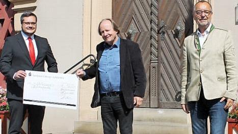 Sparkassenleiter Michael Schmelzer (von links), Intendant des Fränkischen Theatersommers Jan Burdinski und Erster Bürgermeister Jürgen Kohmann bei der Scheckübergabe vor dem Rathaus. Foto: privat