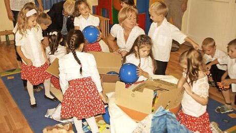 Fleißig packen die Kinder des Pisszentivaner Kindergartens die aus Marktleugast mitgebrachten Spielsachen aus.