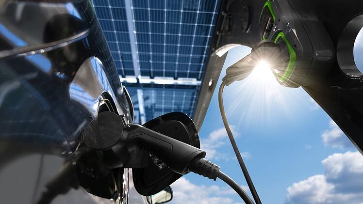 Electric car is charged from a charging station that takes energ