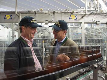 40 000 Flaschen pro Stunde kann die hochmoderne Bügelverschließer-Anlage verarbeiten - entsprechend schnell sausen die Flaschen auch an Technik-Vorstand Jörg Lehmann (rechts) und Braumeister Hermann Nothhaft vorbei. Foto: Alexander Müller