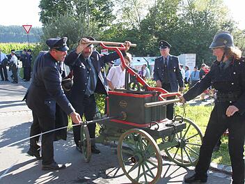 Wasser marsch: Die Freiwillige Feuerwehr Wüstenbuchau-Bechtelsreuth brachte zum Festzug in Rothwind ihre historische Spritze aus dem Jahre 1885 mit. Und Kommandantin Andrea Pfadenhauer-Wagner (rechts) streifte sich sogar eine alte Uniform aus der Zeit um 1900 über. Foto: Stephan Stöckel