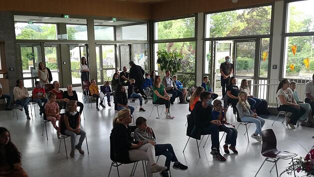 Mit corona-konformem Abstand verfolgten Eltern und Kinder die Abschiedsfeier der Partnerklasse.     Foto: Verena Stephan