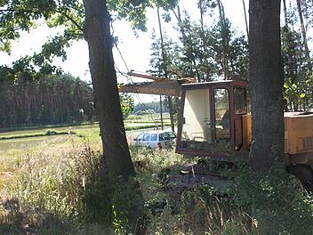 Dieser Bagger im Vordergrund und das Auto dahinter stehen seit Monaten in einem Wäldchen nahe einer Weiherkette bei Klebheim. Ein Fall für den ehrenamtlichen Naturschutzwächter. Fotos: Waltraud Enkert