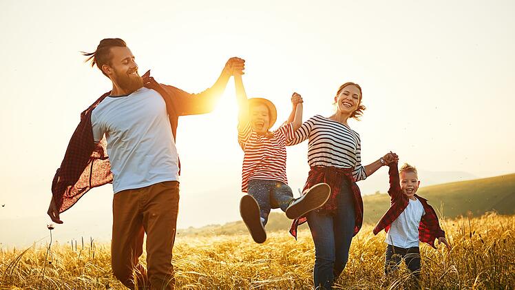 Happy family: mother, father, children son and daughter on sunset
