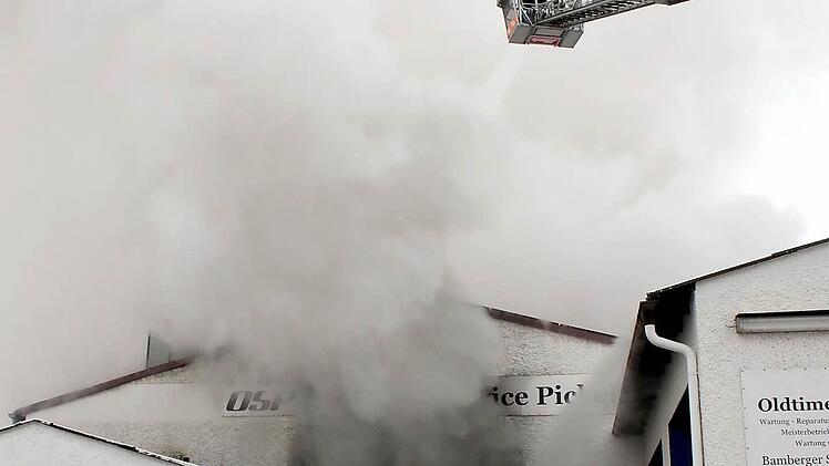 Feuerwehrmänner beim Löschen einer Halle mit Photovoltaik-Anlage.