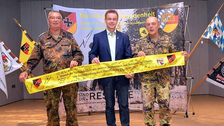 Für die Marktgemeinde Bad Bocklet unterschrieb Kurdirektor Thomas Beck das gelbe Band, das einer Einheit mit auf den Weg in einen Auslandseinsatz gegeben wird (von links: Hauptfeldwebel d.R. Manfred Stange, Kurdirektor Thomas Beck und Oberstleutnant d.R. Johann Schmidt).Peter Rauch