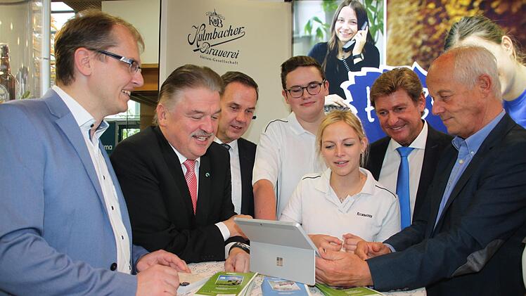 Die duale Studentin Dana Pöhnlein  und der Lehrling Felix Manz von der Kulmbacher Brauerei zeigten (von links)  Bürgermeister  Ralf Hartnack, Landrat Klaus Peter Söllner, Schulleiter  Alexander Battistella, MdL Rainer Ludwig und Michael Pfitzner vom  Arbeitskreis Schule/Wirtschaft ein Ausbildungsvideo. Foto: Stephan Stöckel