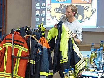 Michael Parzefal von der Ebermannstadfter stellt dem Stadtrat die Feuerwehrjacken vor. Foto: Pauline Lindner