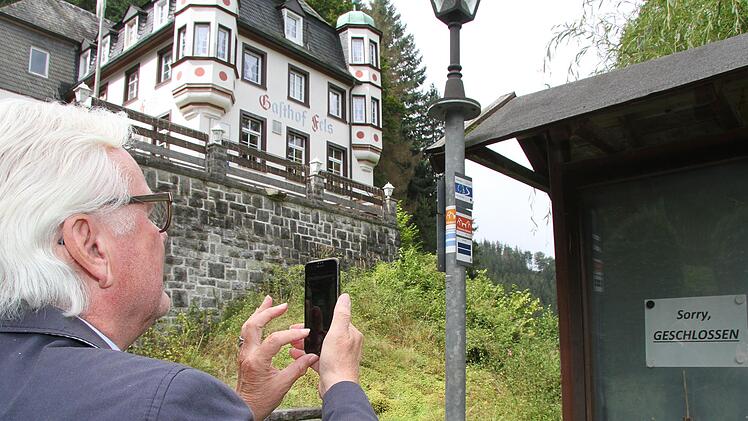 Der Hauptvorsitzende des Frankenwaldvereins fotografiert das "Geschlossen"-Schild und ist froh, dass der malerische Gasthof nicht mehr in den Händen rechter Kreise ist.