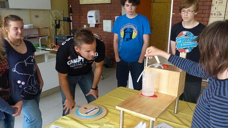 Beim Unterricht an der Montessori-Schule geht es immer darum, den Kindern auf anschauliche Weise abstrakte Dinge zu erklären: Der Leiter der Sekundarstufe, Mathias Schmitt, hat einen Bruchkreisel entworfen, mit dem man Brüche darstellen und  auch Mengen abmessen und mit allen Sinnen erfassen kann. Fotos: Sonja Adam