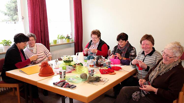 Irmgard Heim (l.) gibt den Frauen Tipps. Hier erklärt sie beispielsweise Gunda Geier, wie man eine Bumerang-Ferse strickt. Foto: Johanna Blum