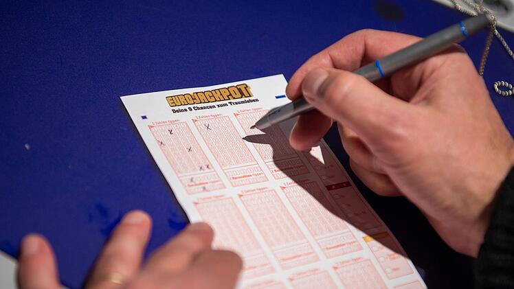 Mann kreuzt auf Lottoschein des Spiels &laquo;Eurojackpot&raquo; Zahlen an