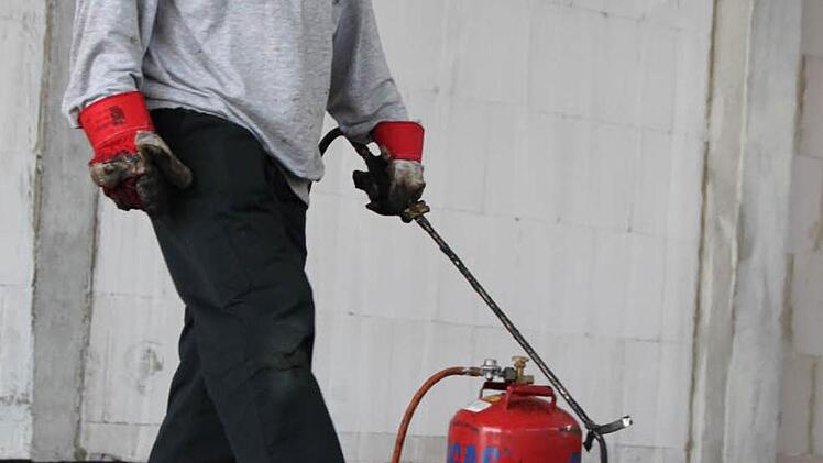 Etwa 800 Grad: Bernd Rudolph klebt Dachpappe auf dem Boden an.