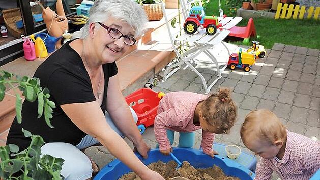 Ursula Then mit Salma und Dahlija, die gerade mal wieder den kleinen Sandkasten vor dem Haus nutzen. Fotos: Barbara Herbst