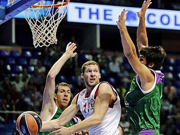 Janis Strelnieks (mit Ball) sucht gegen Malagas Riesen Fran Vazques (l.) und Daniel Diaz einen freien Mitspieler. Foto: Jorge Zapata/dpa