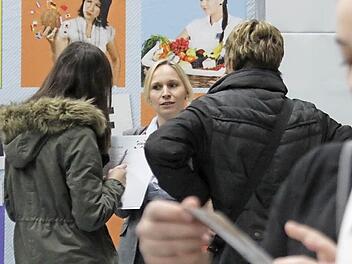 Eine Ausstellerin informiert eine Schülerin und ihre Mutter über die Arbeit im Verkauf.  Foto: Sarah Stieranka