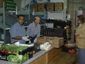 Mahmud und Winfried (von links) sortieren die Lebensmittelspenden, die vor der Weitergabe gesichtet, geprüft und verpackt werden.  Foto: Winfried Ehling