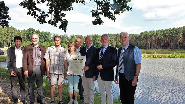 Dem Teichwirt Johannes Weiß (3. v. l.) und seiner Frau Heidi wurde mit einer Urkunde für die Erhaltung und Nutzung der historischen Weiher gedankt.  Foto: Evi Seeger