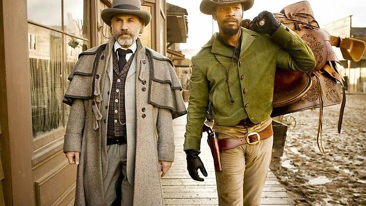 Superstars Seite an Seite: Christoph Waltz und Jamie Foxx (rechts) spielen im Western-Epos Django Unchained unter der Regie von Quentin Tarantino. Foto: Verleih/Sony Pictures
