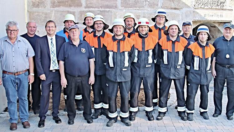 Die behelmten neun Feuerwehrleute aus Wasmuthhausen unterzogen sich mit Erfolg einer Leistungsprüfung. Mit auf dem Foto von links: Gemeinderat und Feuerwehrvereinsvorsitzender Eberhard Vogel, federführender Kommandant Wolfgang Harnauer, Bürgermeister Wolfram Thein und Ausbilder Uwe Hein, sowie von rechts: KBI Peter Hegemann und Prüfer Robert Müller Foto: Helmut Will