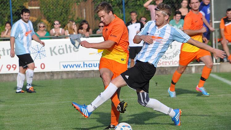 TSV Steinberg - FC Burggrub: Gästespieler Markus Wimmer (weiß-blaues Trikot) kommt einen Tick zu spät und kann nicht verhindern, dass Felix Müller den Ball zu einem Mannschaftskameraden weiterspielt. Foto: Herbert Kalb