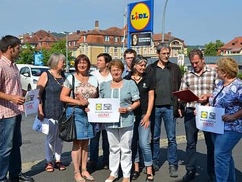 Ein knappes Dutzend Landwirte übergab zusammen mit Kreisbäuerin Rita Jörg und dem Kreis-Geschäftsführer des Bayerischen Bauernverbandes Georg Scheuring als Antwort auf die "Grundanforderungen für Lieferanten" nun einen ebenfalls 50 Punkte umfassenden Grundanforderungskatalog für Lidl-Verkaufsmärkte. Hier bei der Besprechung der Aktion vor dem Kissinger Lidl-Markt. Foto: Peter Rauch