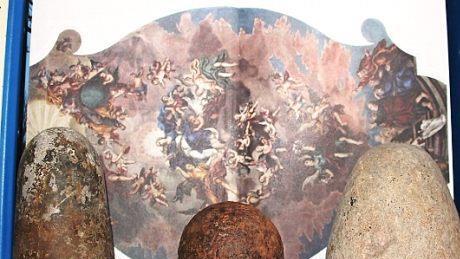 Vor einem Foto des von Johann Peter Herrlein geschaffenen Deckengem&auml;lde in der Wallfahrtskirche am Findelberg Saal sind die beiden M&ouml;rserst&ouml;&szlig;el des Grabfeldmalers sowie die vermutlich aus der Zeit des Drei&szlig;igj&auml;hrigen Krieges von den Schweden in K&ouml;nigshofen 1631 zur&uuml;ckgelassene Kanonenkugel, die Peter Schindler aufbewahrte, abgebildet.