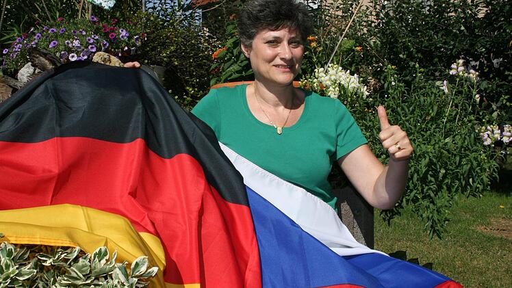 Albina Baumann mit der deutschen und russischen Flagge.