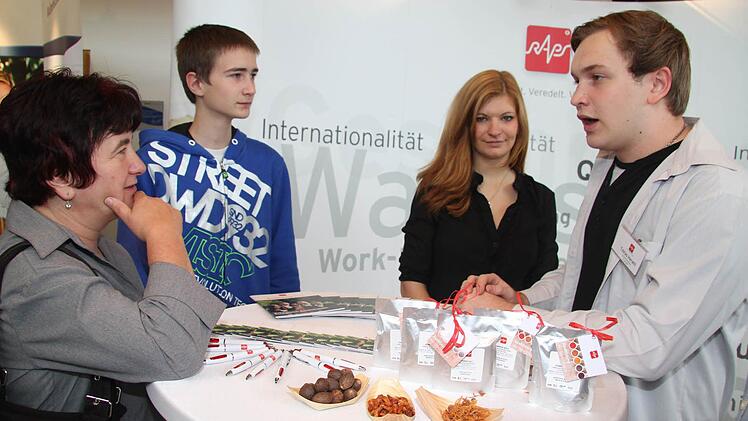 Fachinformatiker Tobias Herath und Laura Wunderlich, ebenfalls von Raps beraten die Interessierten: Steffen Weißmann aus Mainleus interessiert sich für die Berufsrichtung Fachinformatiker, aber Elektroniker wäre eventuell auch etwas, meint er. Seine Mutter Hannelore Weißmann ist mit dem Zehntklässler auf der Messe Foto: Sonja Adam