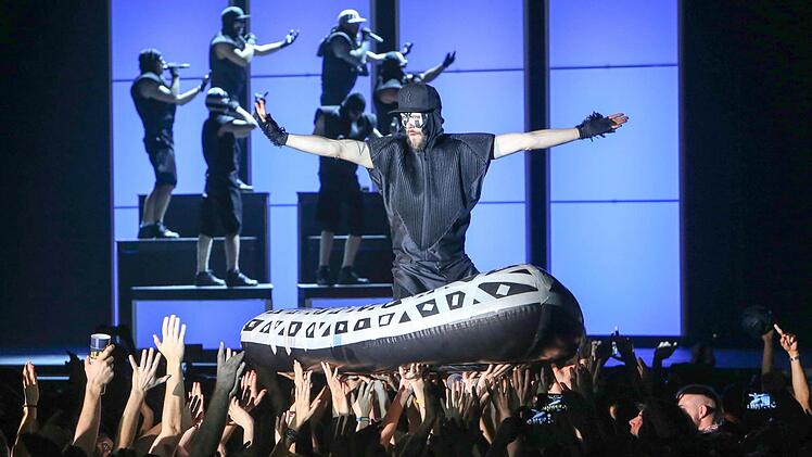 Auf der Woge der Fans l&auml;sst sich ein Bandmitglied durch die Arena hieven. Fotos: RiegerPress