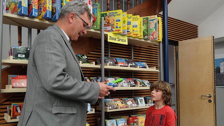 Bürgermeister Helmut Dietz heißt den achtjährigen Tim Walter aus Schottenstein in der Gemeindebücherei im KOMM in Untermerzbach als 500. Leser herzlich willkommen.