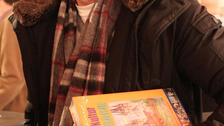 Hubert Kolling - der ebenfalls zu den Autoren des Buches zählt- deckte sich mit drei Buchexemplaren ein.  Foto: Markus Häggberg