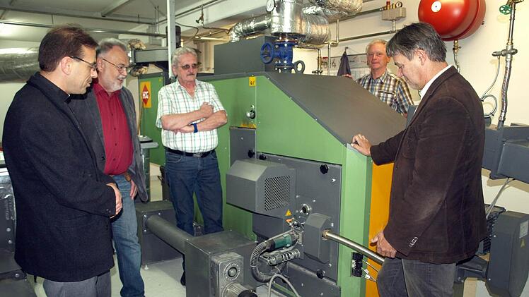Interessiert begutachten Pfarrer Richard Reis, Kirchenpfleger Walter Schmittdorsch, Pfarrgemeinderatsvorsitzender Klaus Wunder, Bruno Beierlorzer und Bürgermeister Gerhard Wunder (von links ) den Brenner der neuen Heizungsanlage. Foto: Susanne Deuerling