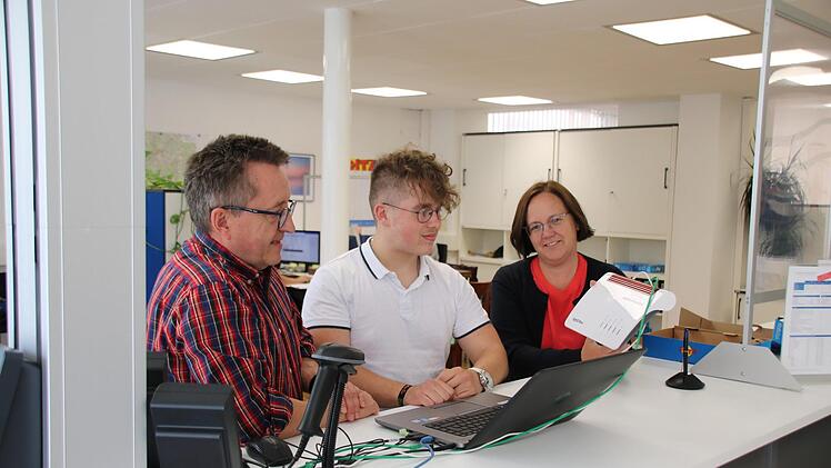 Der 17-jährige Fabian Gröber (Mitte) absolviert bei den Hammelburger Stadtwerken eine Ausbildung zum IT-System-Kaufmann. Hier schauen ihm Betriebsleiter Stephan Dausacker (links) und Geschäftsführerin Anja Binder (rechts) beim Konfigurieren eines Routers über die Schulter. Foto: Ralf Ruppert