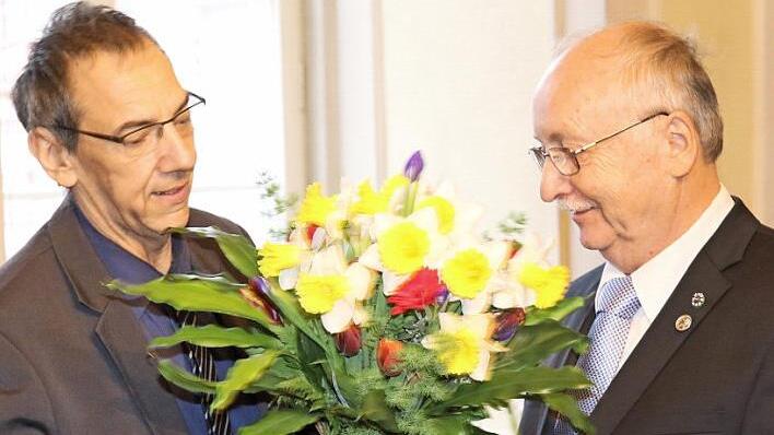 Dritter Bürgermeister Thomas Nowak dankt Hubert Joppich mit der Medaille und mit Blumen.