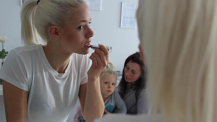 Michelle wird von ihrer kleinen Schwester Lia und Mutter Daniela beobachtet.