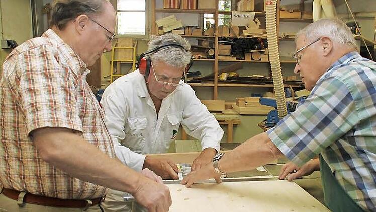 Drei von rund 80 Ehrenamtlichen, die den Familientreff mit handwerklichem Einsatz und vielen Ideen bereichern: Gerhard Weith, Gerd Deichsel und Horst Wirth (von links) haben in der Schreinerwerkstatt ein zweites Zuhause gefunden und werkeln für den guten Zweck. Fotos: Dagmar Besand