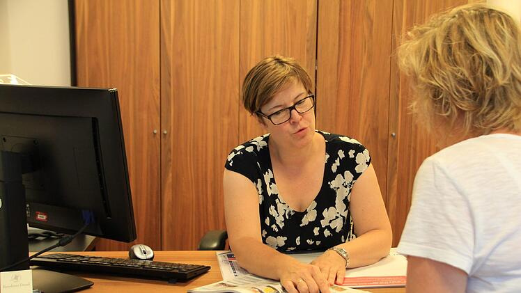 Astrid Dresel zeigt in einem Reisekatalog Beispiele für den nächsten Urlaub: Foto: Franziska Rieger
