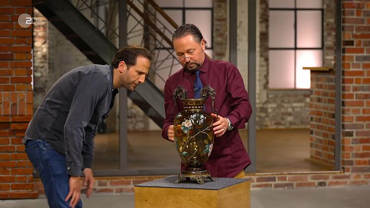 Wolfgang Pauritsch sah sich das Schmuckstück aus der Nähe an: "Das Glas ist mindestens 100 Jahre alt und wunderschön bemalt." Walter Lehnertz bat aus der Ferne: "Klopf mal, ob die ganz ist." Pauritsch tat dies. Julian Schmitz-Avila tippte auf eine böhmische Herkunft.