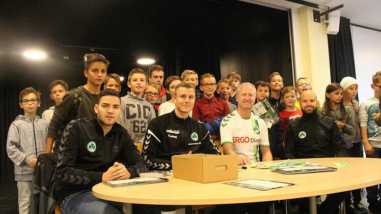 Richard Magyar (2. v. l.) und Lehrer Peter Baum (in weiß) sowie Verantwortliche der Spielvereinigung mit Fans  Yannick Hupfer