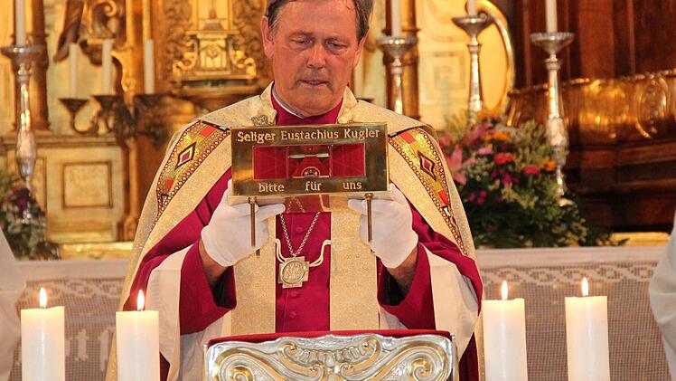 Msgr.Georg Holzschuh erteilt mit dem Reliquienschrein den Segen. Foto: Blum