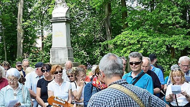 Vor dem Rückert-Denkmal im Park der Familie, der an das Wohnhaus Friedrich Rückerts grenzt, sangen die Teilnehmer der Wanderung das Lied "Aus der Jugendzeit" aus der Feder des Dichters. Foto: S. Hackenberg
