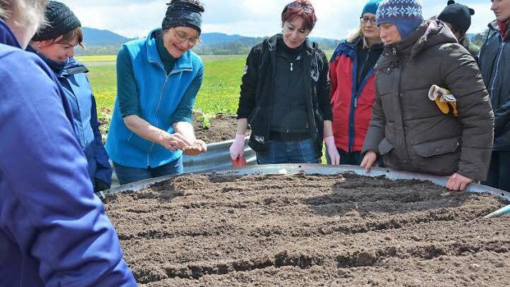 Draußen wird es endlich wärmer: Höchste Zeit, die Gemüsebeete im Garten vorzubereiten. Unter der Anleitung von Regina Burkhardt lernen angehende Hauswirtschafterinnen die Grundlagen des Hausgartenbaus. Und auch in den geflochtenen Hochbeeten der Traumgarten AG wachsen schon die ersten Salat- und Gemüsepflänzchen heran. Foto: Dagmar Besand
