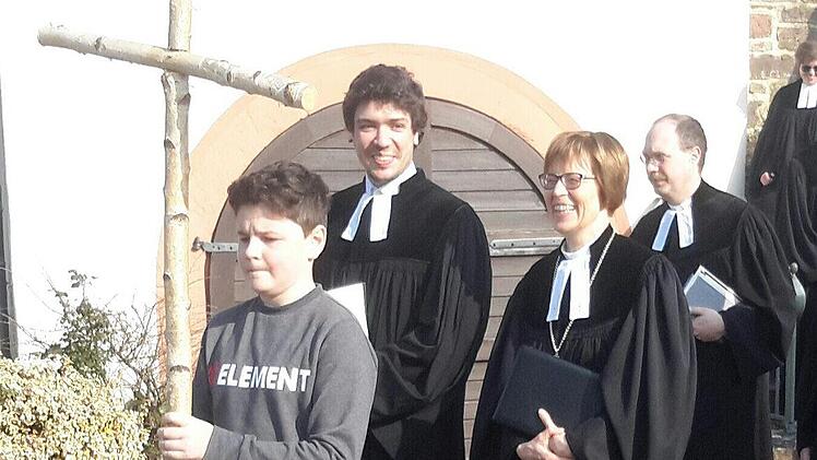 Ein junger Kreuzträger ging nach dem Gottesdienst beim Auszug aus der Kirche voran. Mit einem glücklichen Lächeln auf den Lippen folgten ihm (von links) der neue Pfarrer Niels Hönerlage, Regionalbischöfin Gisela Bornowski, Vakanzvertreter Thomas Kohl und Dekan Till Roth.Foto: Rolf Pralle