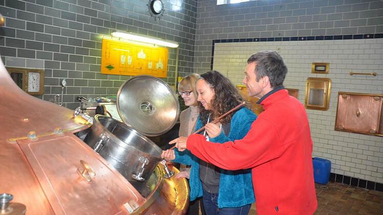 Louisa Kern (Mitte) entnimmt aus dem Braukessel (Sudpfanne) eine Probe, um die Stammwürze festzustellen. Dabei wird sie beraten von Geschäftsführerin Anette Höfner und Braumeister Oliver Kaufmann. Foto: K.- H. Hofmann